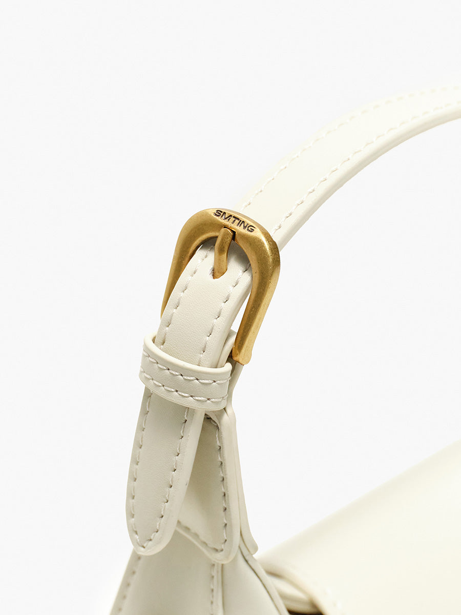 Crescent-shaped handbag with saddle design