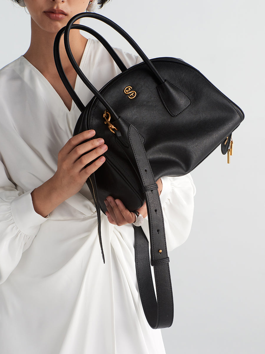 Half-moon shaped boston handbag