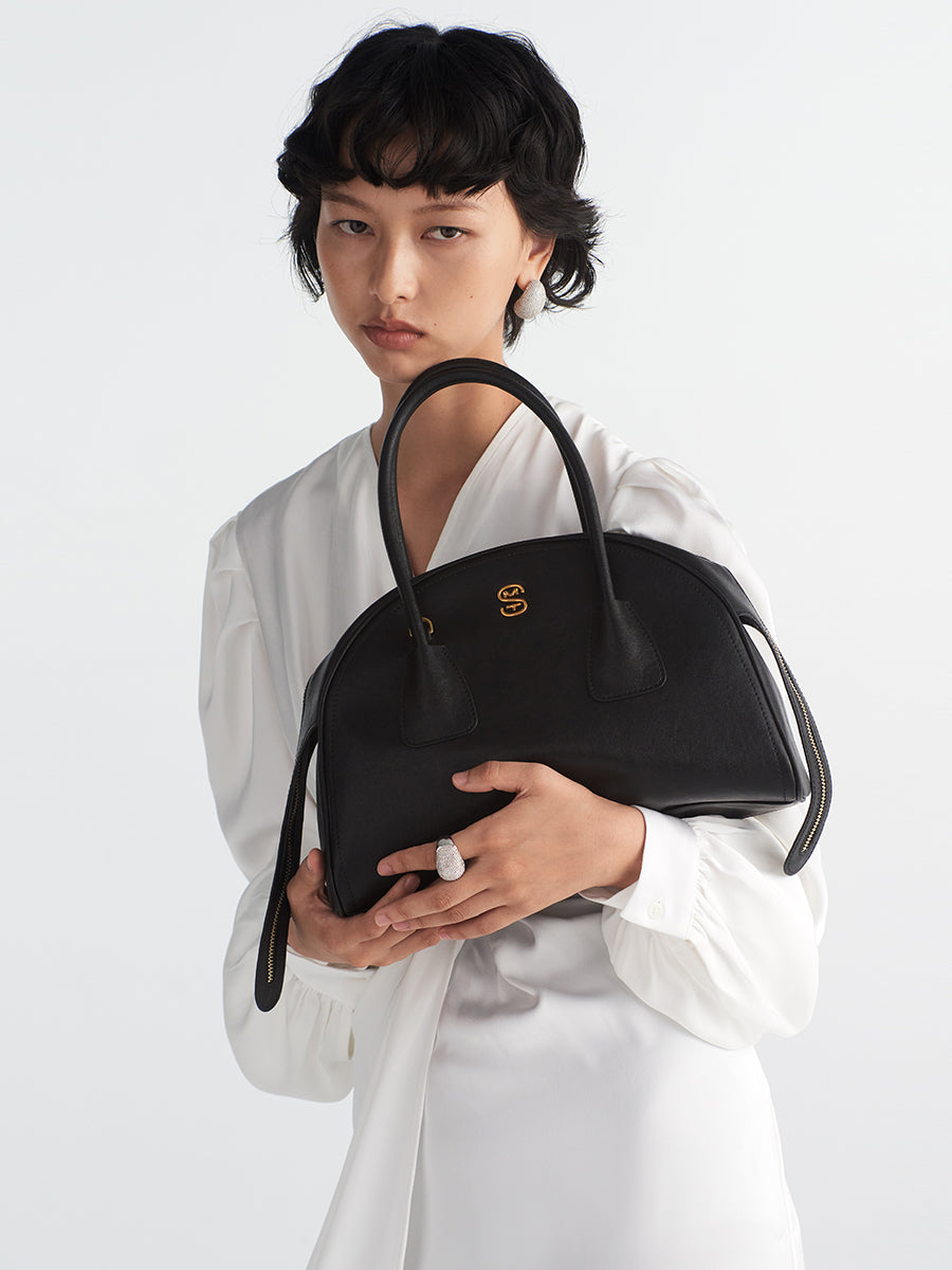 Half-moon shaped boston handbag