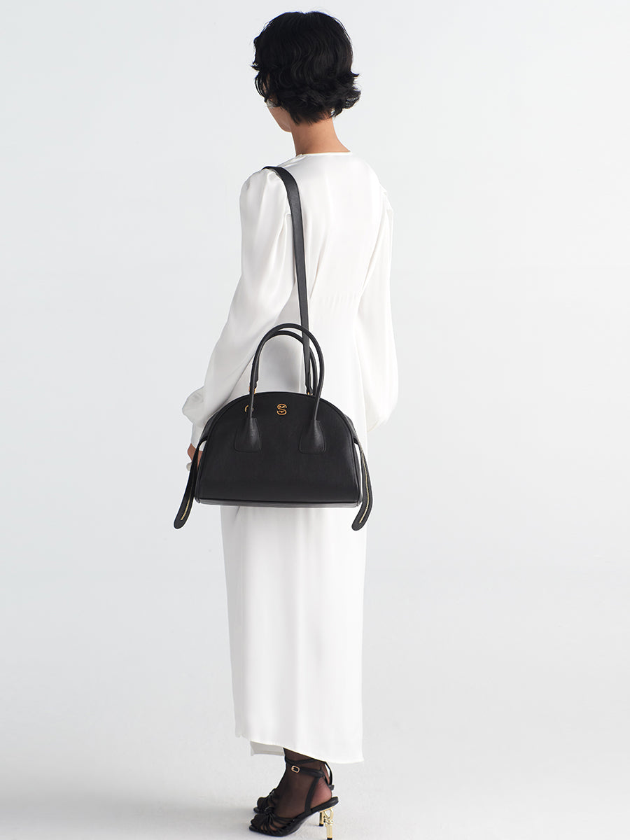 Half-moon shaped boston handbag