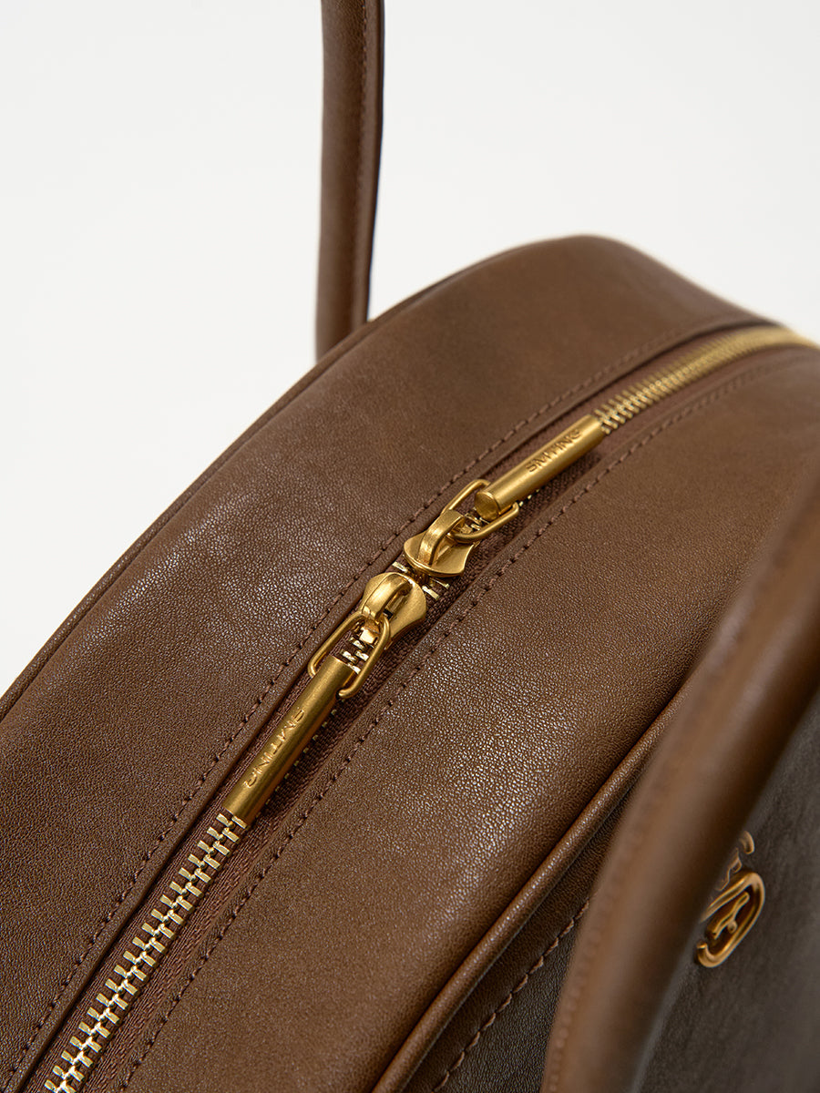 Half-moon shaped boston handbag