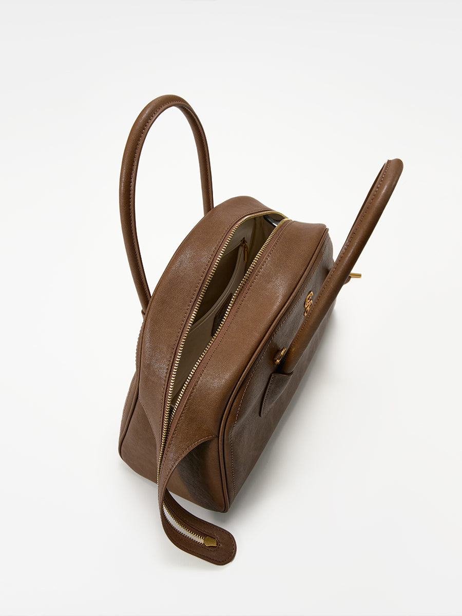 Half-moon shaped boston handbag