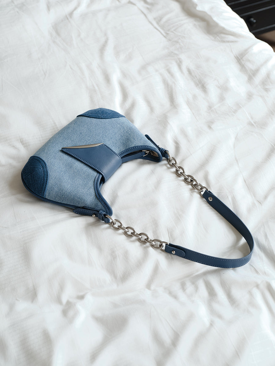 Crescent-shaped compact underarm saddle bag