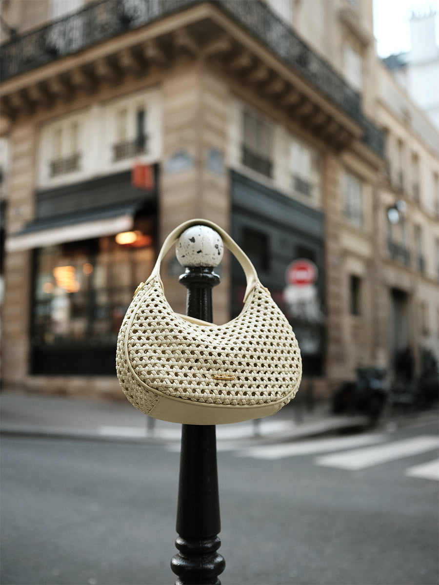 Moon-shaped woven handbag